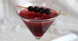 Berry Fusion Martini with blueberries on cocktail pick