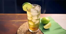 Bourbon and Sprite cocktail with lime slice on table