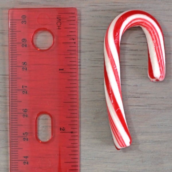 Candy cane next to ruler
