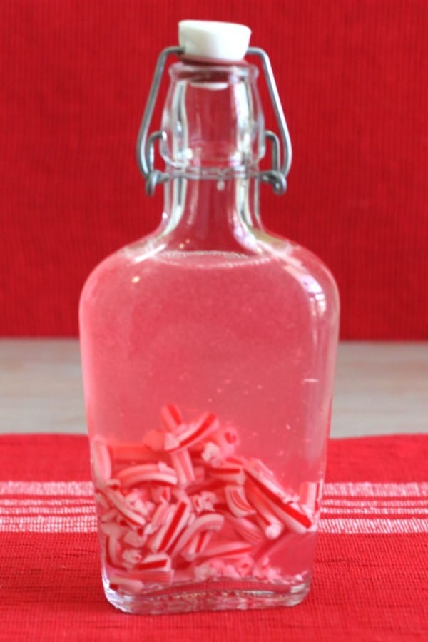 Vodka in flask turning pink from being shaken with candy canes