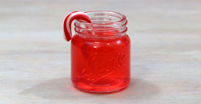Candy Cane Vodka in shot glass with candy cane