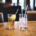 Cocktails with eco-friendly straws in glass and paper
