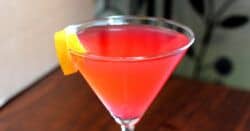 Cosmopolitan cocktail on bar with lemon twist