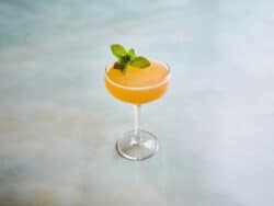 Cuban Cocktail in coupe glass with mint sprig