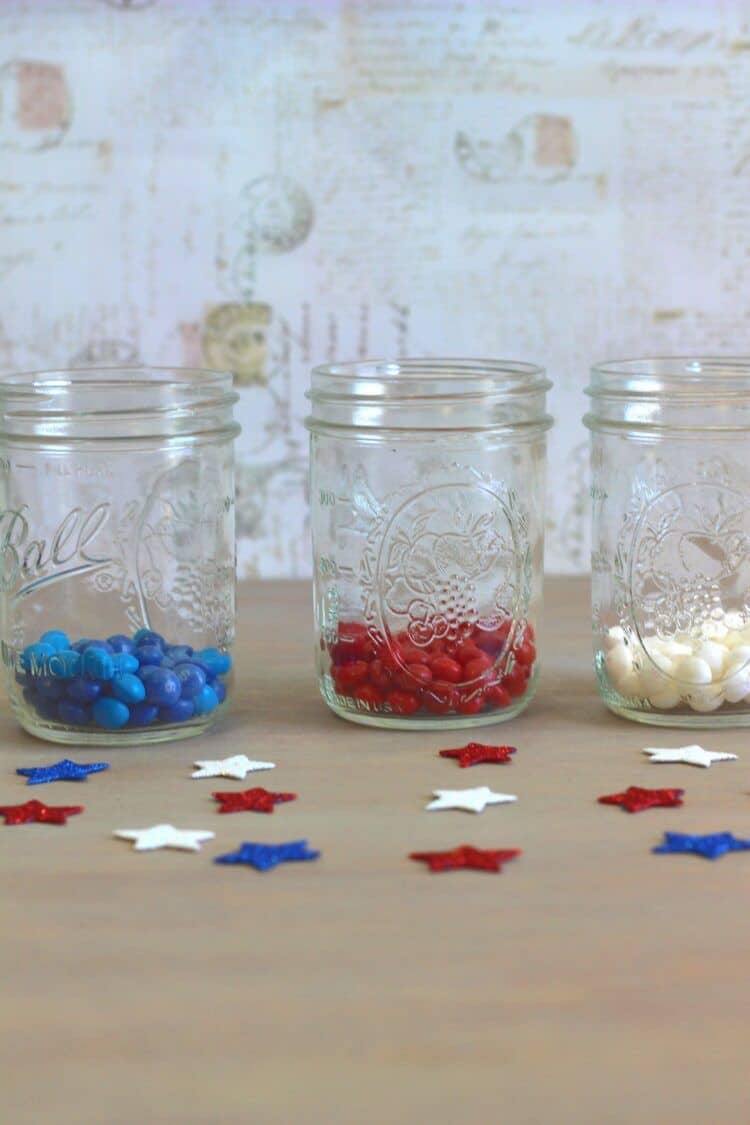 Ball jars with different colors of Skittles America Mix candies