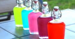 Jolly Rancher Vodka in flasks on a patio table