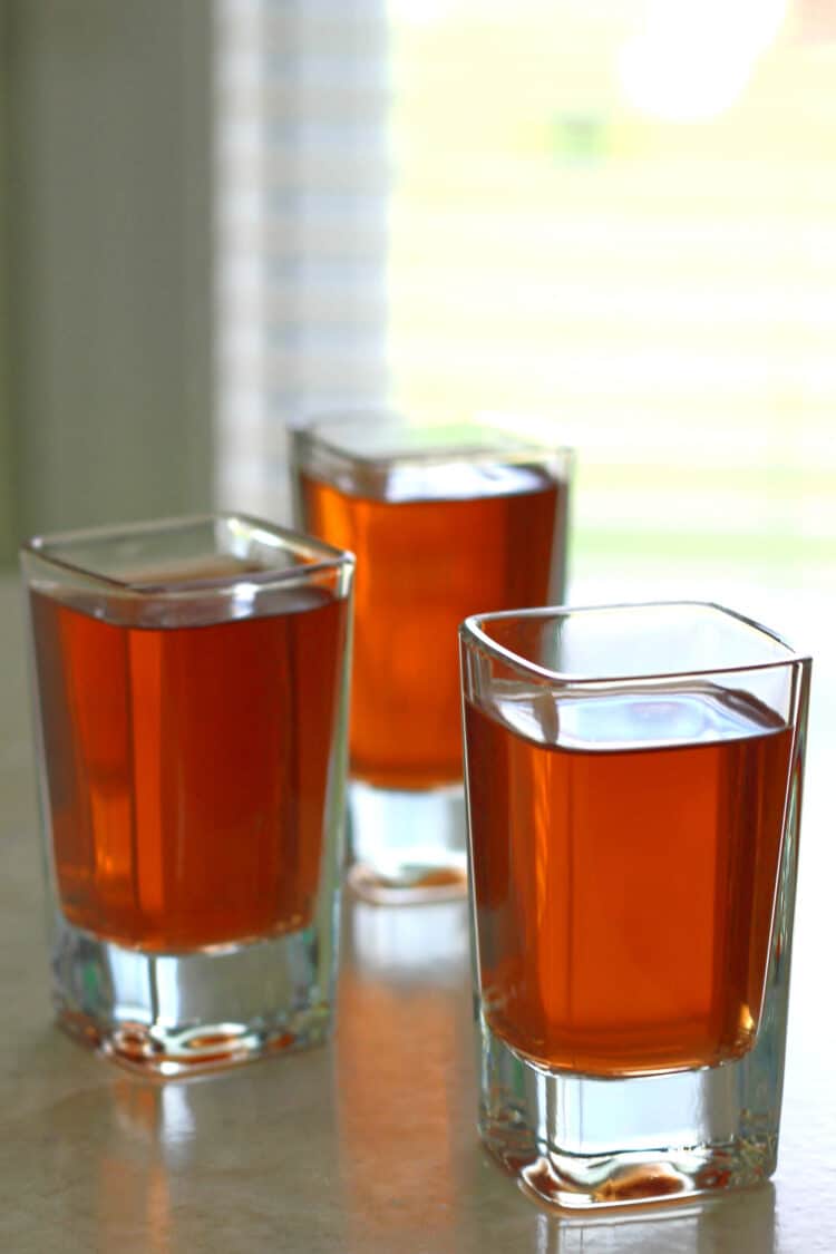 Three Kahlúa drinks in shot glasses on table