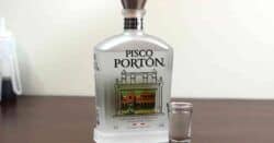 Bottle of Pisco Portin next to shot glass of same