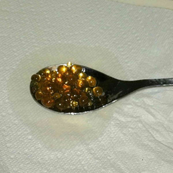 Spoon with Rum Caviar drying on paper towel