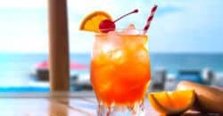 Rum Punch cocktail with cherry and orange garnish