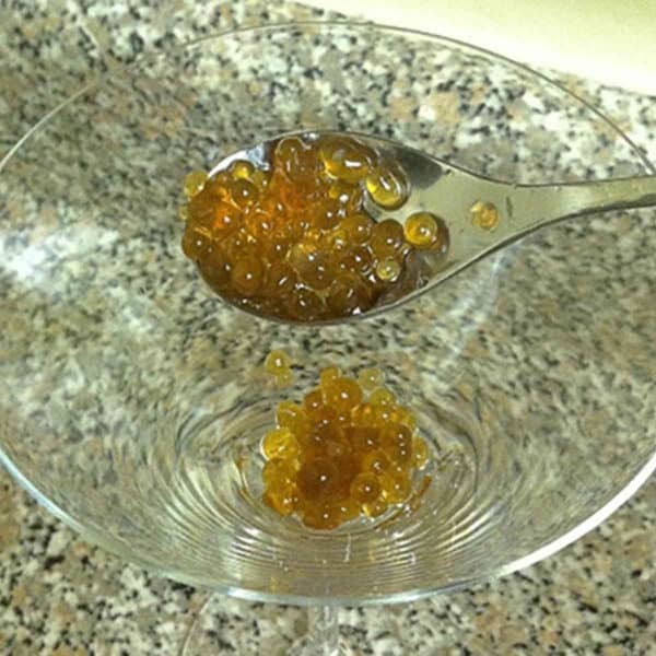 Spooning Rum Caviar into glass