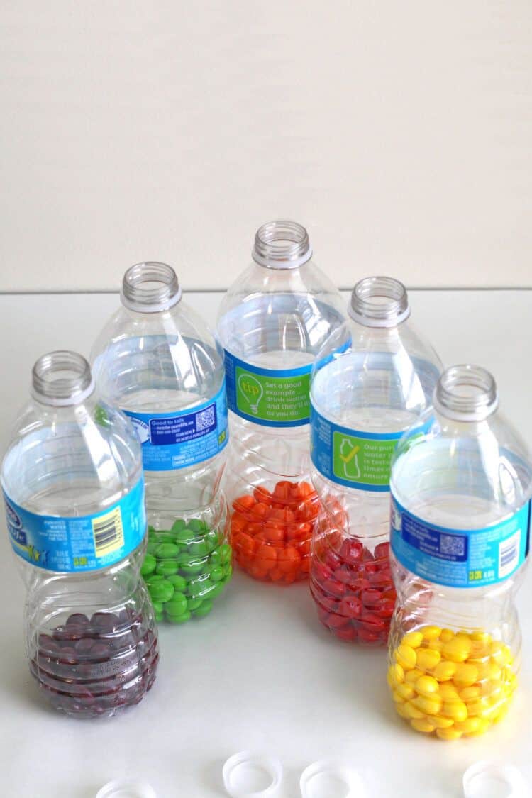 Skittles separated by flavor in empty bottles