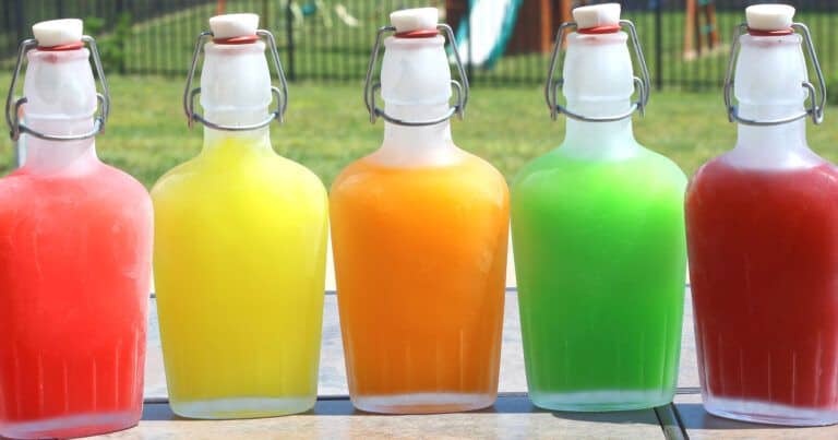 Multicolored Skittles Vodka in flasks on patio table