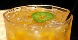 Spicy Apricot Margarita with sliced jalapeño floating on top
