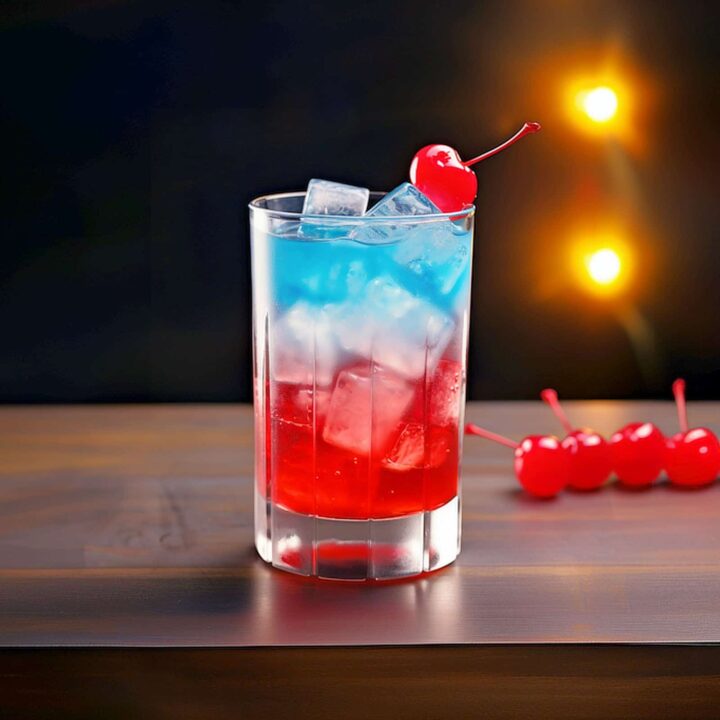 Red and blue Superman Cocktail with cherry