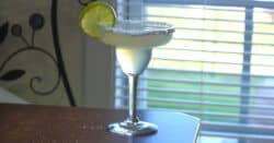 Margarita made with triple sec in front of window