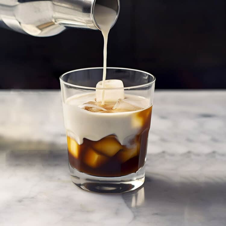 Cream being poured into White Russian cocktail